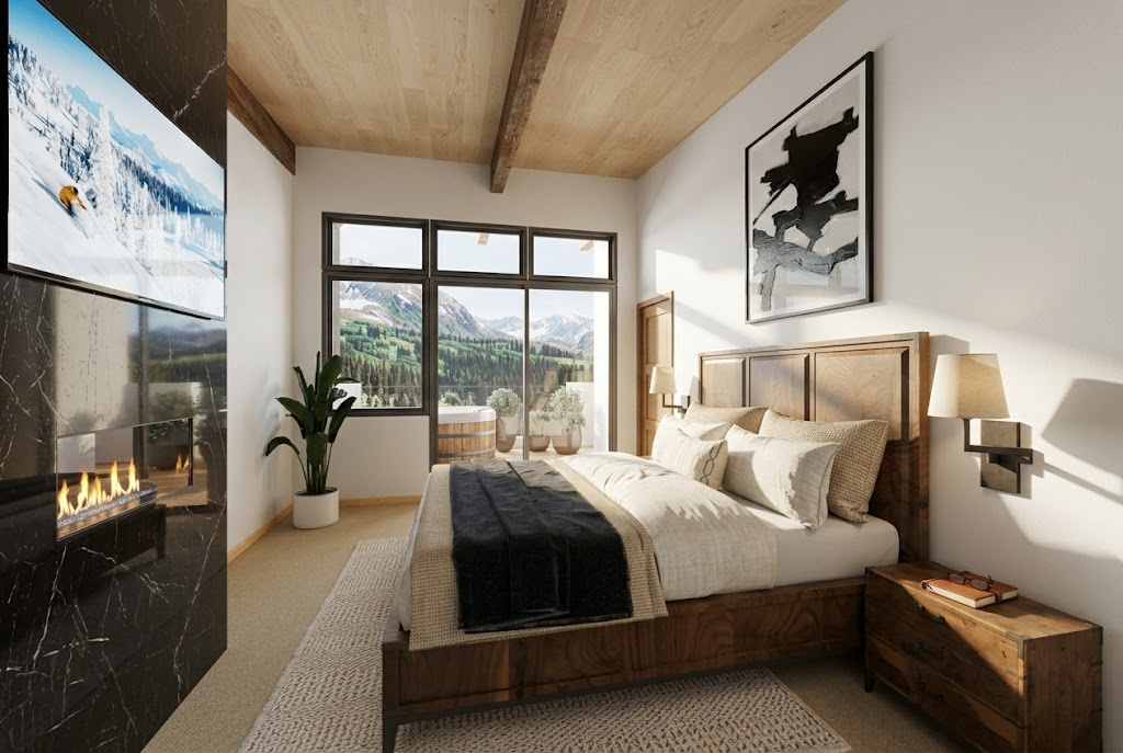 Guest bedroom with gas fireplace, framed art, and valley view