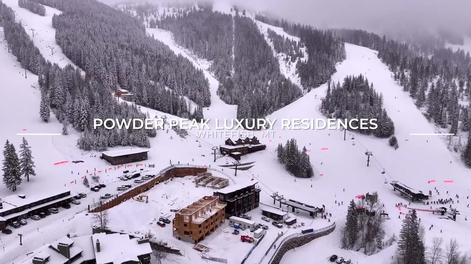Snow-covered Whitefish Mountain ski runs above the Powder Peak development